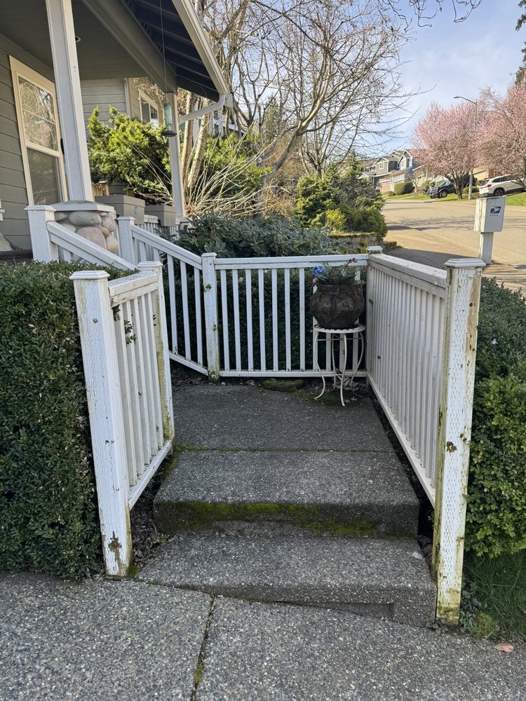 Weathered porch railing and gate with peeling white paint before repainting