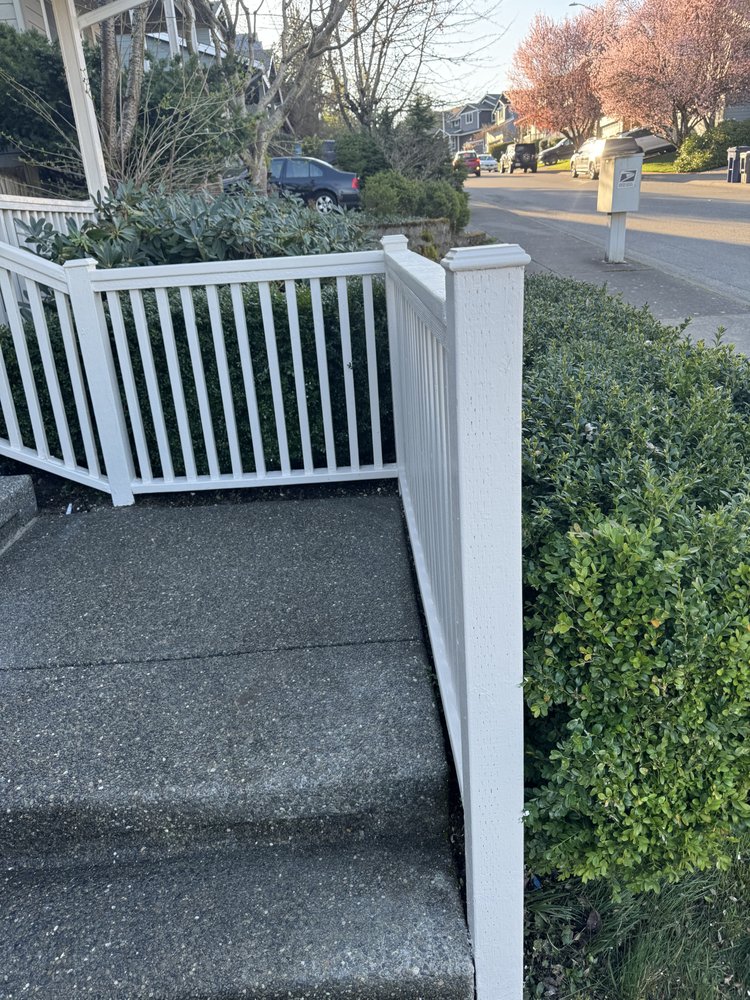 Crisp white repainted railing running along the front walkway after painting